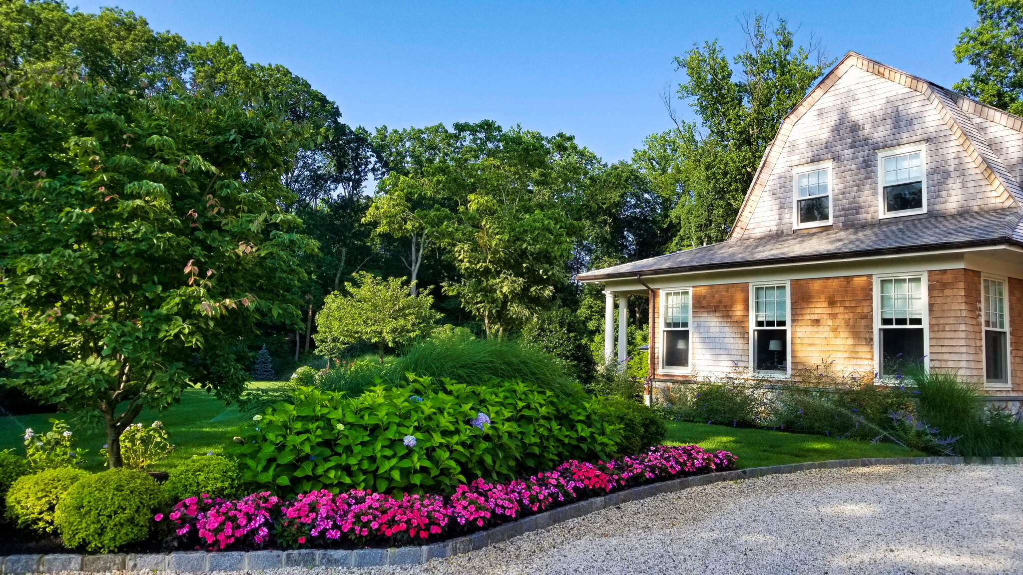 A charming house nestled in a well-landscaped yard with an irrigation and sprinkler system expertly installed by Neave Group